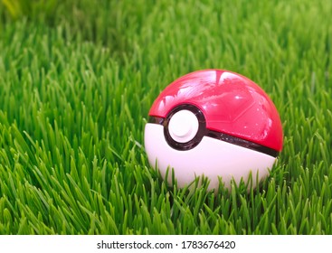 Japan, Tokyo - July 26, 2020 - Pokéball Lying On Green Grass, Decoration In Front Of The Pokémon Center Mega Tokyo In Ikebukuro 