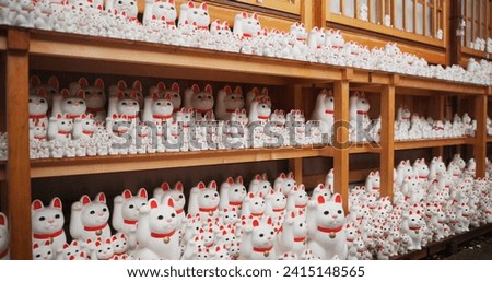 Japan, traditional and neko maneki or group in shop for good luck cat, fortune or culture. Sculpture figure, gotokuji and store for travel destination in Tokyo for local history, spiritual or gift