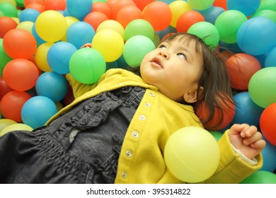 Japanese baby girl playing in ball pool (1 year old) - Shutterstock ID 395314822