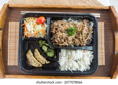 Japanese Bento Box With Fatty Beef, Gyoza And White Rice