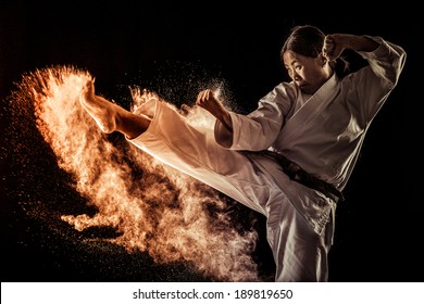 Japanese black belt athlete performing a kick