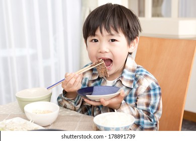 Japanese Boy Eating Meat