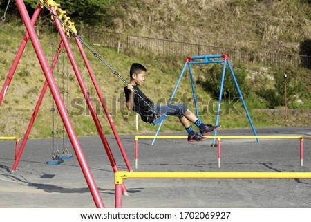 Similar – old swing on the playground on the street