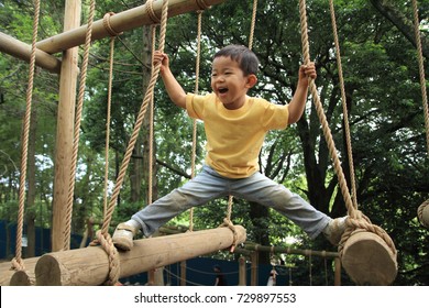 Japanese boy playing at outdoor obstacle course (3 years old) - Powered by Shutterstock