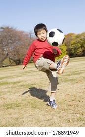 Japanese Boy Playing Soccer