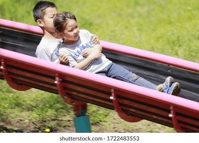 Japanese Brother And Sister On The Slide (10 Years Old Boy And 5 Years Old Girl)