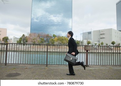 Japanese Business Man Running In The Front Of The Building