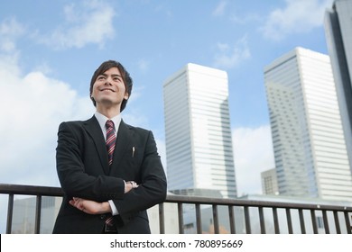 Japanese Business Man Standing In Front Of The Building