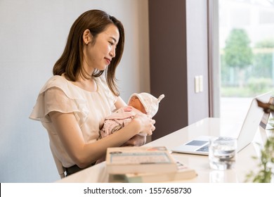 Japanese Business Mother Holding Baby With Laptop 