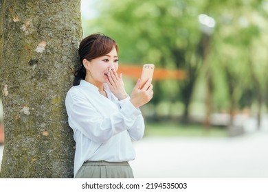 Japanese Business Woman Happy To See Her Smartphone