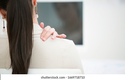 Japanese business woman holding shoulder - Shutterstock ID 1669718710