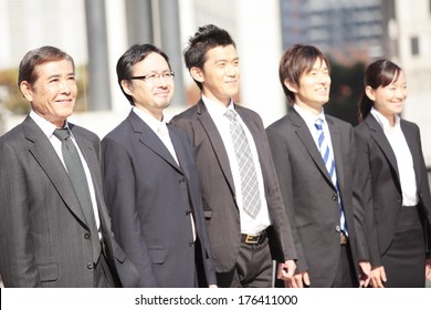 Japanese Businessmen Staring Ahead