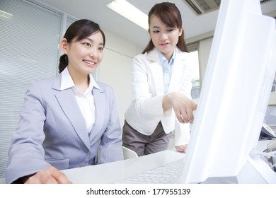 Japanese businesswoman talking while looking at the computer - Shutterstock ID 177955139