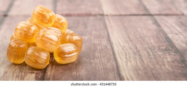 Japanese Caramel Honey Hard Candy Over Wooden Background