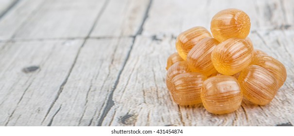 Japanese Caramel Honey Hard Candy Over Wooden Background