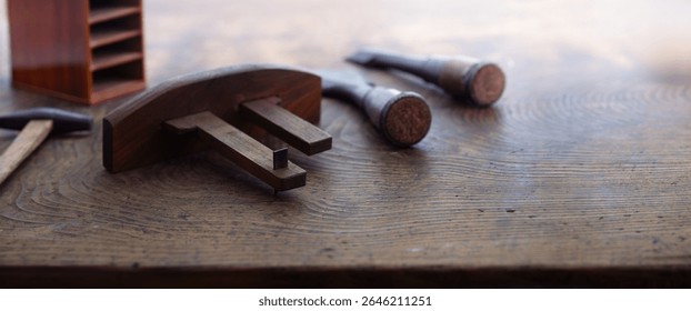 Japanese carpentry. Japanese woodworking tools on an old rustic work table. Japanese kebiki, chisels, and hammers, in light and shadow.  - Powered by Shutterstock - Get 15% off with code: PIKWIZARD15