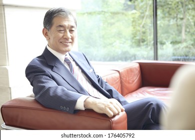 Japanese CEO Sitting On The Sofa