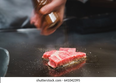 Japanese Chef Cooking Wagyu Beef On Hot Teppanyaki