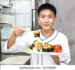 Japanese Chef With A Plate Of Sushi