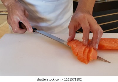 japanese chef sliced raw fish on white cutting board for salmon sushi . - Shutterstock ID 1161571102