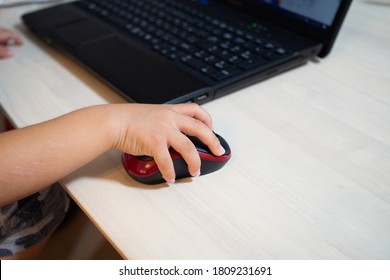 A Japanese Child Operating A Mouse On A Computer