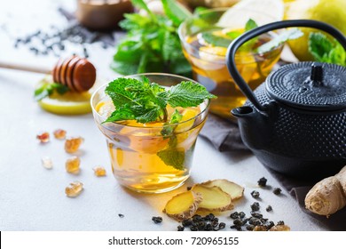 Japanese chinese tea teapot lemon ginger honey mint on a white table. Warm drink beverage infusion in glass for cold flu winter fall days - Powered by Shutterstock