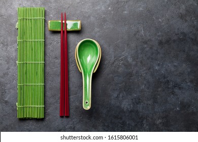 Japanese Chopsticks And Soup Spoon On Stone Table. Asian Food Concept. Top View Flat Lay With Copy Space