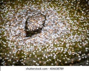 Japanese Coin Was Thrown By Traveler Into Wishing Well In Kyoto, Japan (selective Focus)