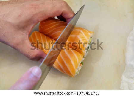 Japanese cooking. cutting salmon roll
