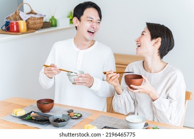 Japanese Couple Eating Breakfast At Home