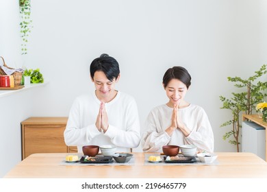 Japanese Couple Eating Breakfast At Home