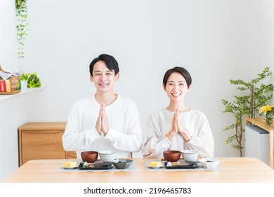 Japanese Couple Eating Breakfast At Home