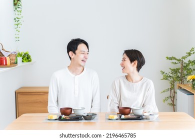 Japanese Couple Eating Breakfast At Home