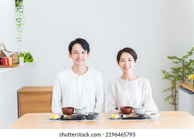 Japanese Couple Eating Breakfast At Home