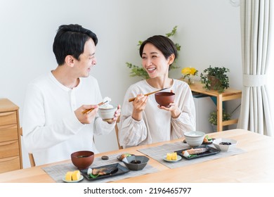 Japanese Couple Eating Breakfast At Home