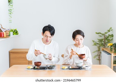 Japanese Couple Eating Breakfast At Home