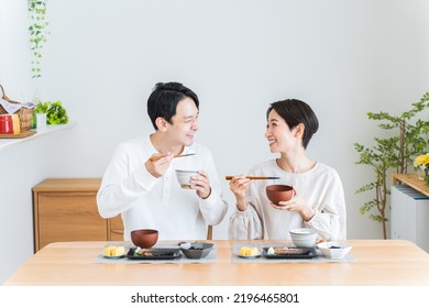 Japanese Couple Eating Breakfast At Home