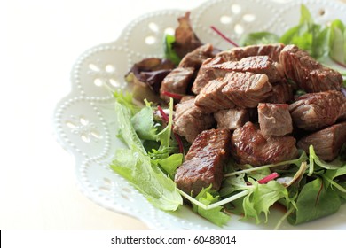 Japanese Cuisine,Cube Steak Served With Baby Leaf Salad