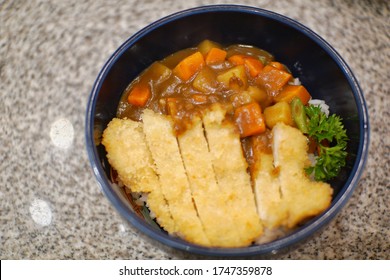 Japanese Curry Rice With Meat, Carrot And Potato Close-up On A Plate On A Table. Horizontal Top View From Above. Rice With Deep Fried Chicken And Curry In Japanese Style Or Katsu Kare.