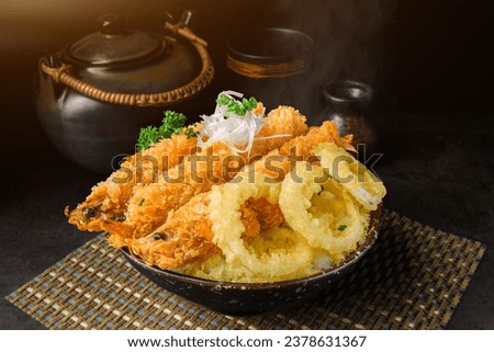 Japanese deep fried shrimps with rice bowl donburi with dark background.