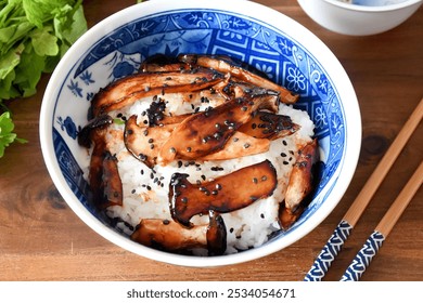 Japanese donburi bowl with king oyster mushrooms features sautéed mushrooms over steamed rice, seasoned with soy sauce and mirin. It’s a savory and hearty dish, often garnished with green onions. - Powered by Shutterstock