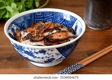 Japanese donburi bowl with king oyster mushrooms features sautéed mushrooms over steamed rice, seasoned with soy sauce and mirin. It’s a savory and hearty dish, often garnished with green onions. - Powered by Shutterstock