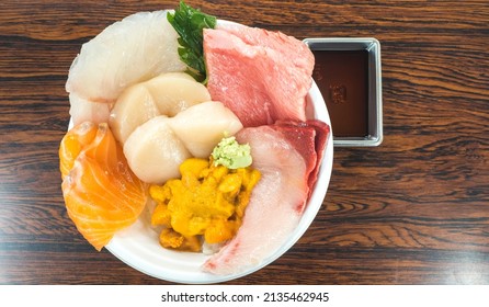 Japanese Donburi food set. Donburi set is the Japanese rice bowl top with sashimi, uni (sea urchin and hokkaido scallop) Uni and Scallop donburi with miso soup in lunch set. top view Japanese food.