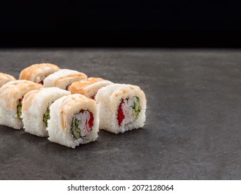 Japanese Ebi Shrimp Sushi Roll With Crab Meat Sticks, Cucumber, Cream Cheese Inside Roll. Asian Dish Pieces With Prawn On Top On Concrete Background. Copy Space Image. Single Object. Inside Out Sushi