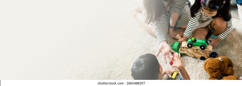 Japanese Family Playing With Toys On The Floor Design Space Banner