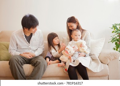 Japanese Family Sitting On The Sofa