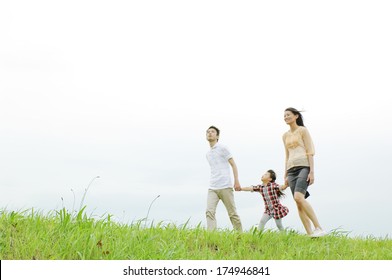 Japanese Family Walking On The River Bed