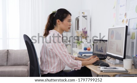 japanese female employee happy about completing a complex analytical task. asian office lady dealing with project with caution and finally having the work done.