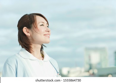 Japanese Female Nurse Looking Up To The Sky