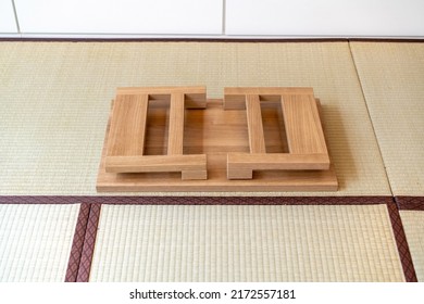 A Japanese folding table made of wood is set at the center of the picture, suitable for eating or reading, on tatami mats.